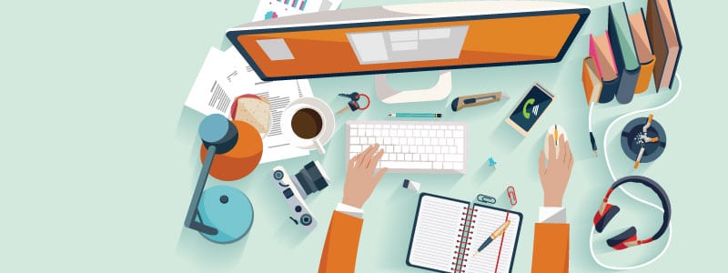 computer desk with headphones, notebook, phone, digital trends