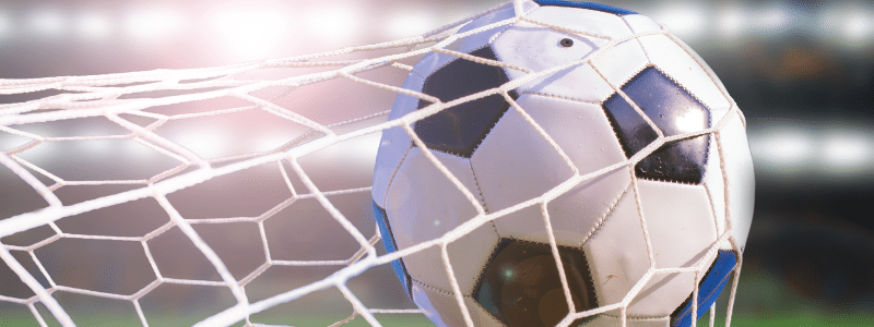 Picture of a soccer ball going into a net