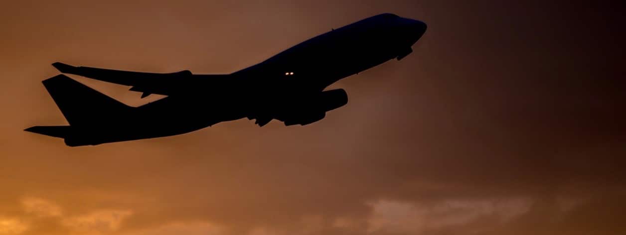 Airplane taking off with clouds in the sky