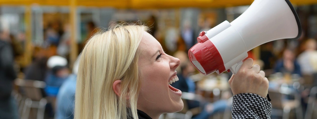 Woman yelling into a megaphone