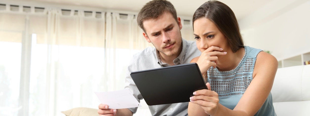 Worried couple checking product review online
