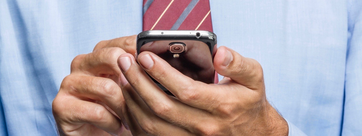 cropped image of businessman on smart phone