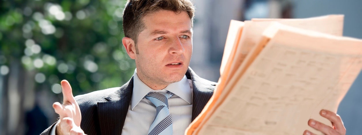 businessman reading negative coverage about his brand