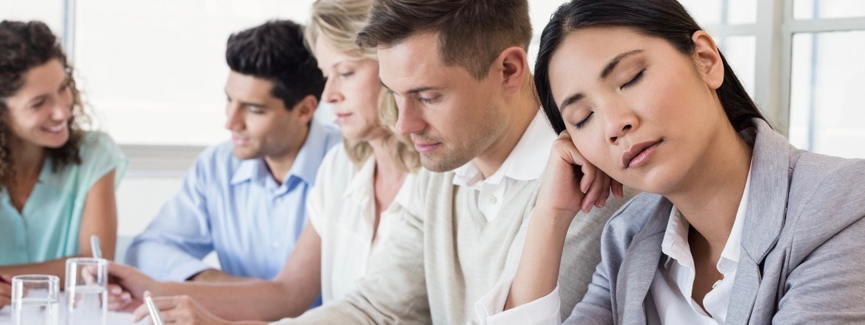 businesswoman falling asleep during meeting in the office