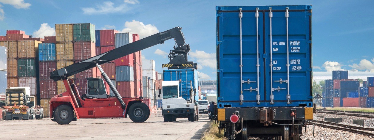 forklift handling container box loading to freight train