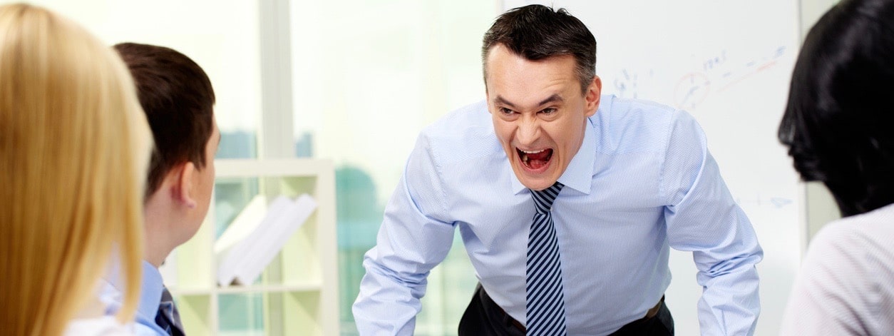 Angry businessman shouting at his workers