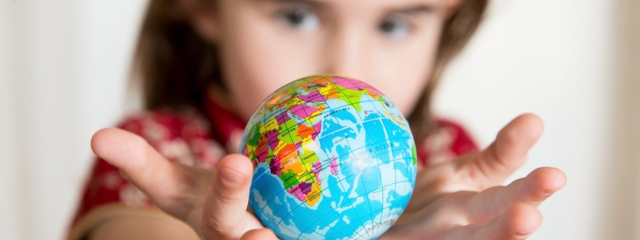 Girl holding little World Globe on her Hands