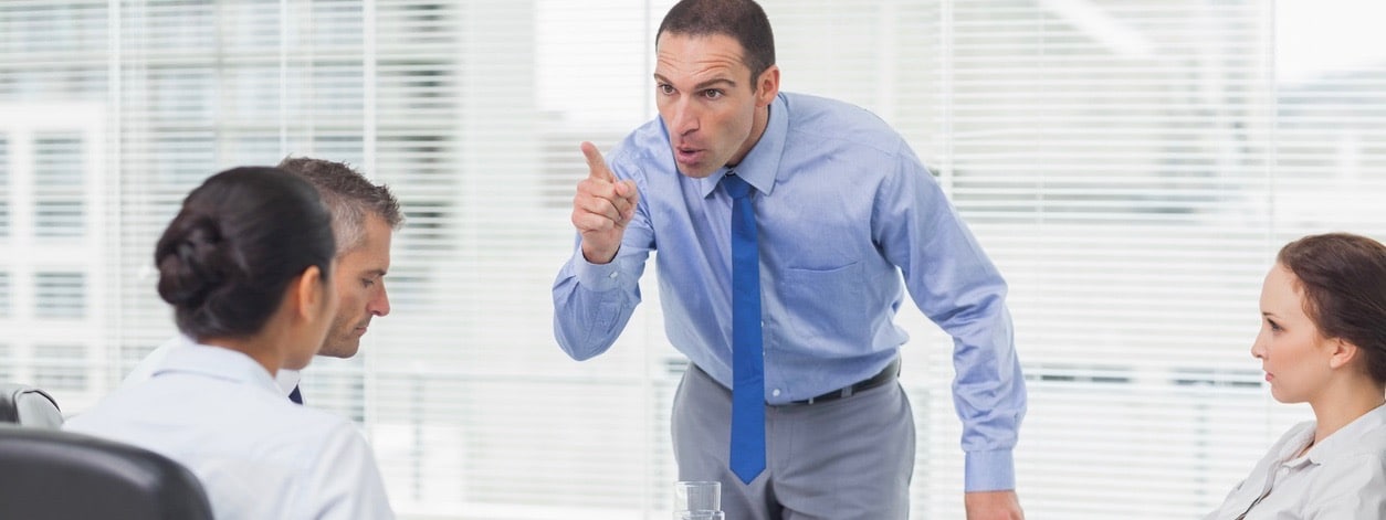 Angry executive pointing out his employee in bright office