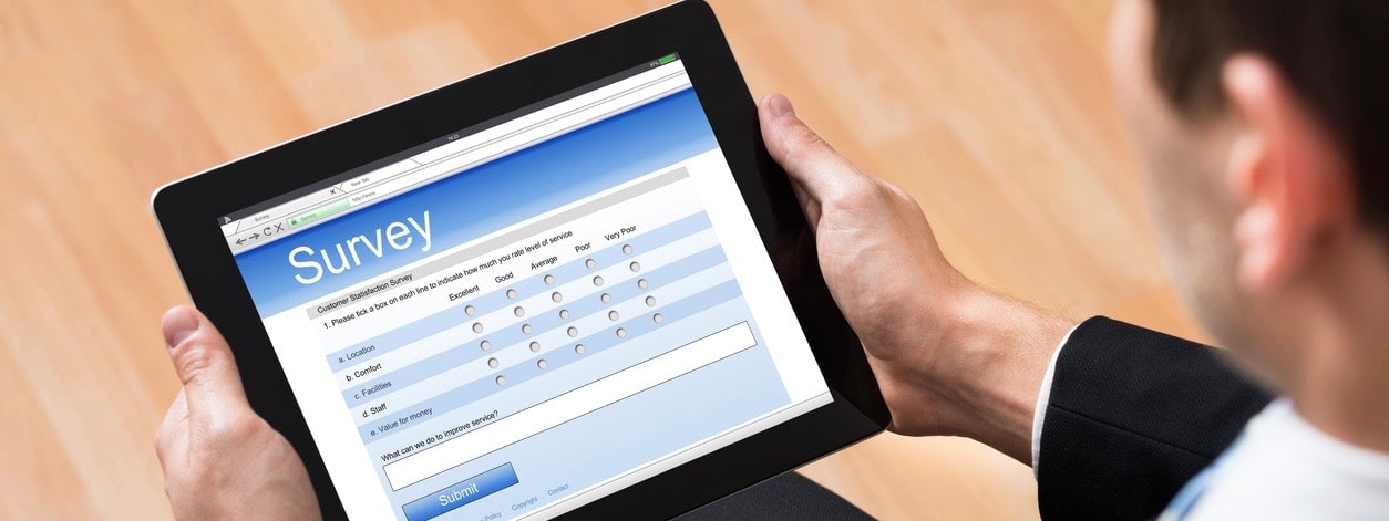 Businessman Looking At Blank Online Survey Form On Digital Tablet
