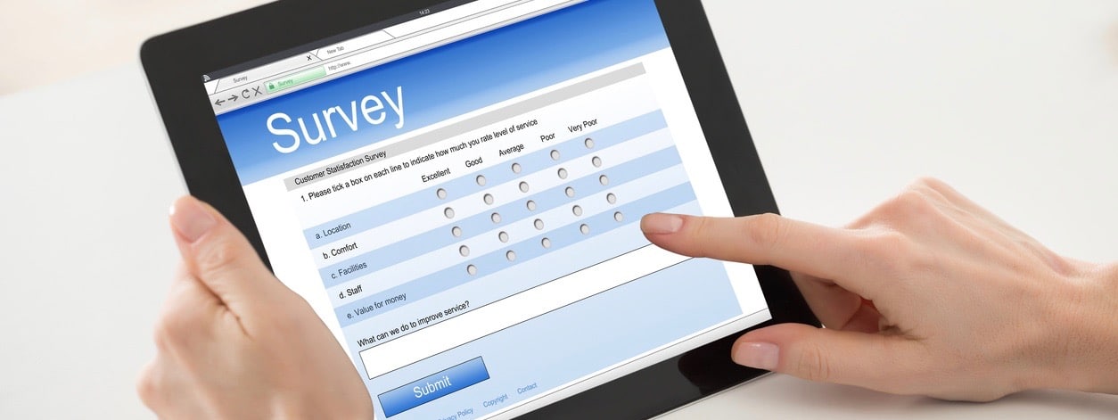 Woman Filling Online Survey Form On Digital Tablet