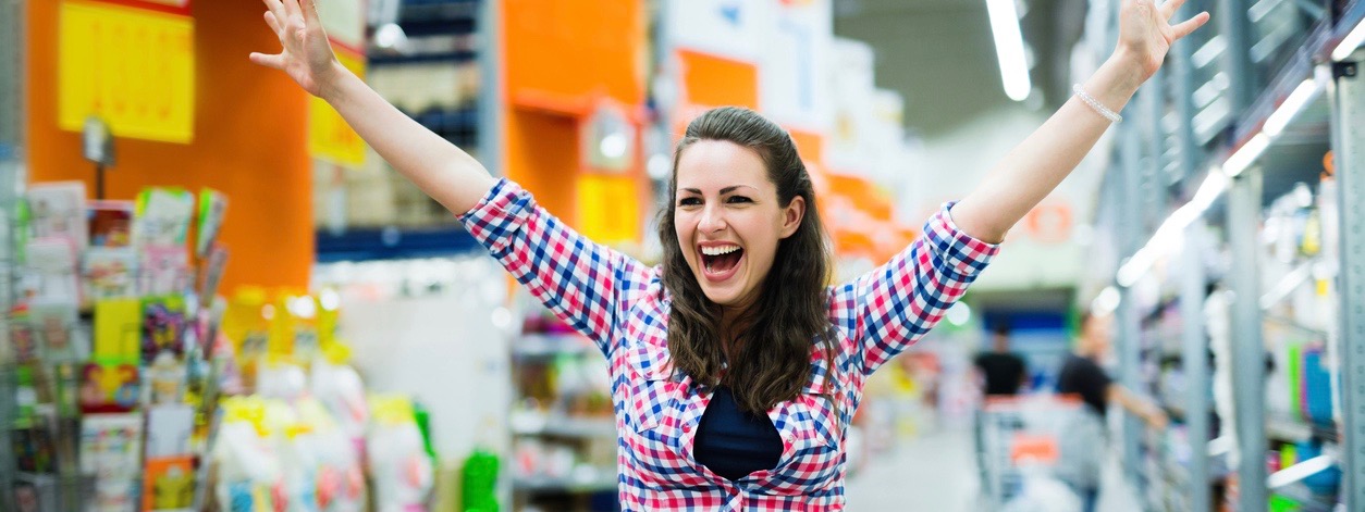 Shopaholic woman enjoying shopping spree in supermarket
