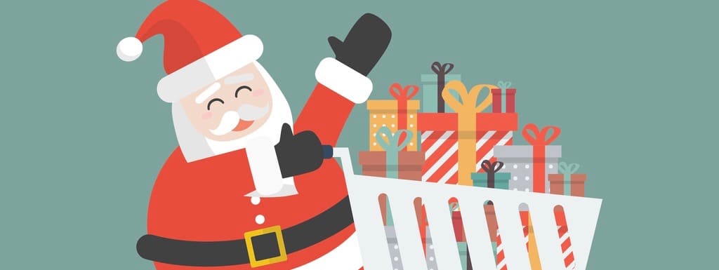 Santa claus push a shopping cart with piles of presents.