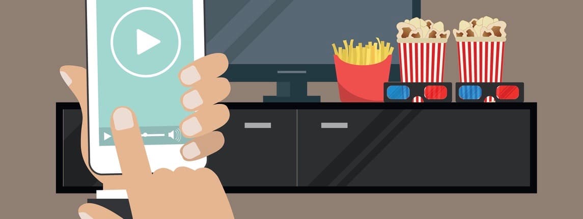 Hand holding a remote controller. There is a "play" button on the display of the remote controller in the picture. There is also a home cinema, curbstone, 3D glasses, popcorn, french fries