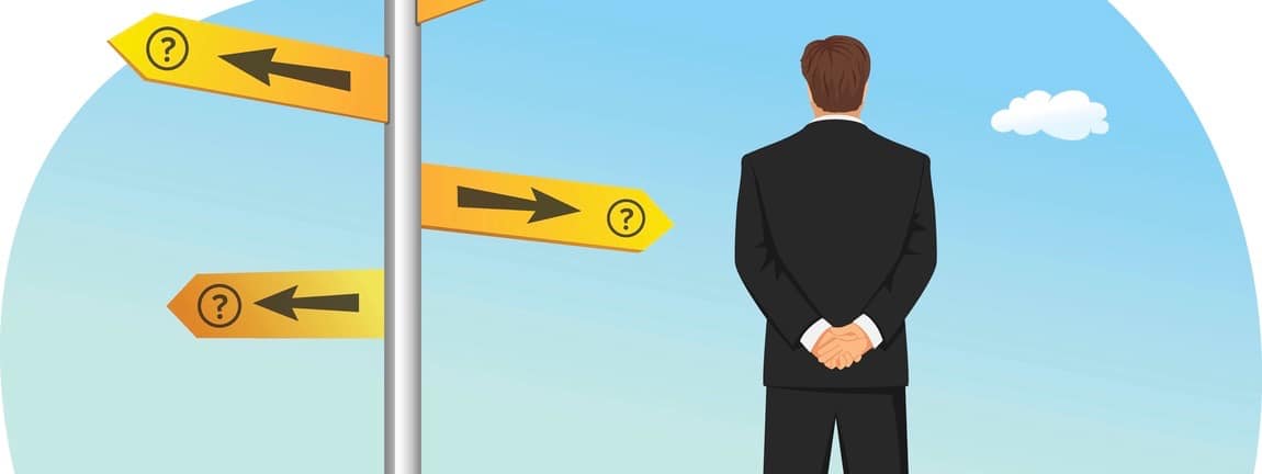Businessman has to choose between different routes. He is looking on a road sign with directions.