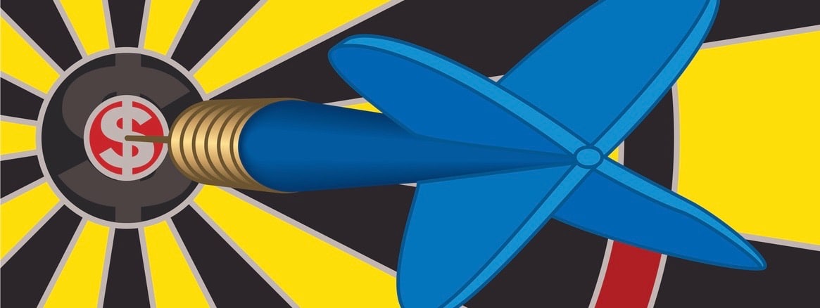 close-up of blue dart on a dollar sign placed on the bulls-eye of the dart board