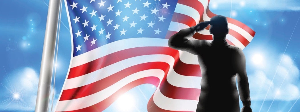 Veterans Day design of an American Flag waving in the wind with a silhouette saluting soldier