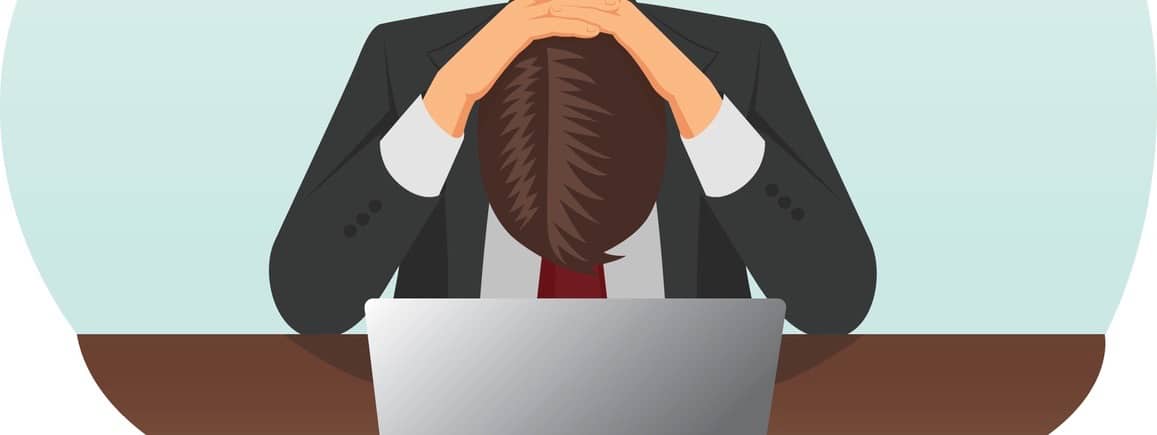 Failed and stressed businessman is tired to work on the computer. He put hands on the head.