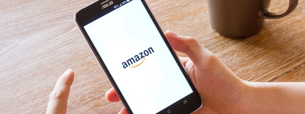 man hand holding screen shot of Amazon application