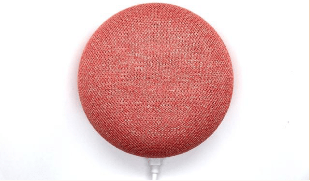 A red Google Home Mini device against a white background
