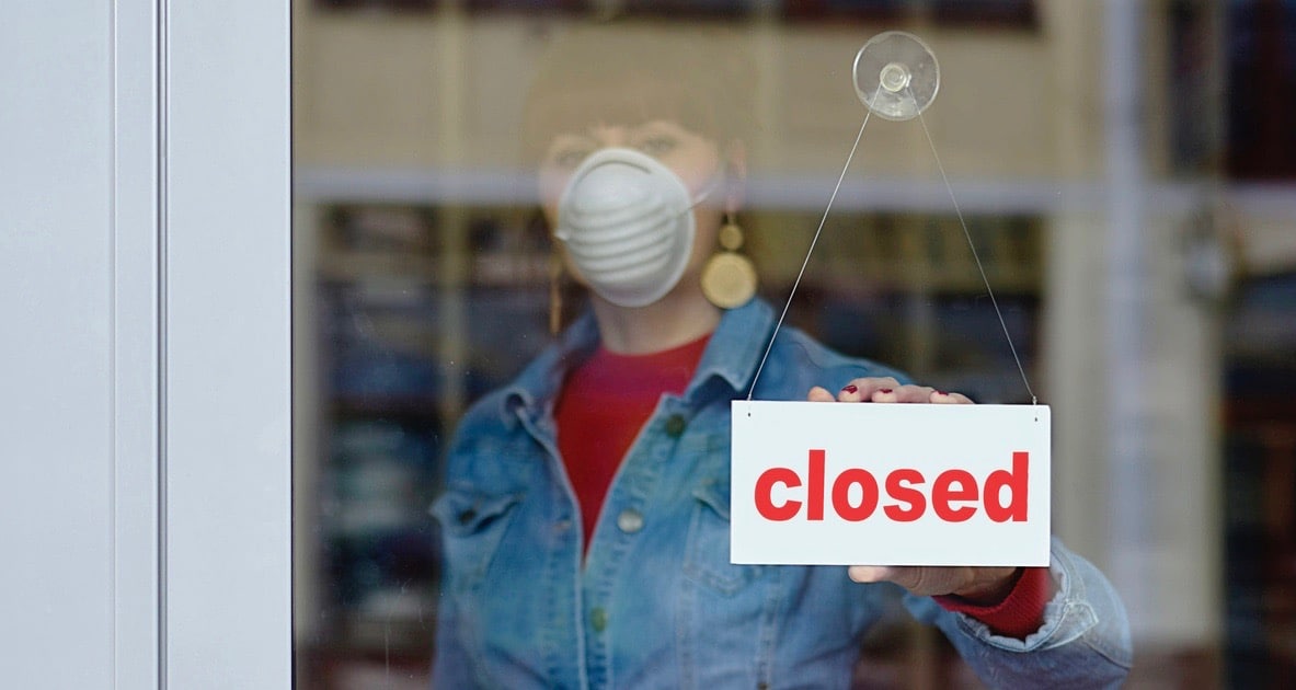 woman in closed shop with mask 