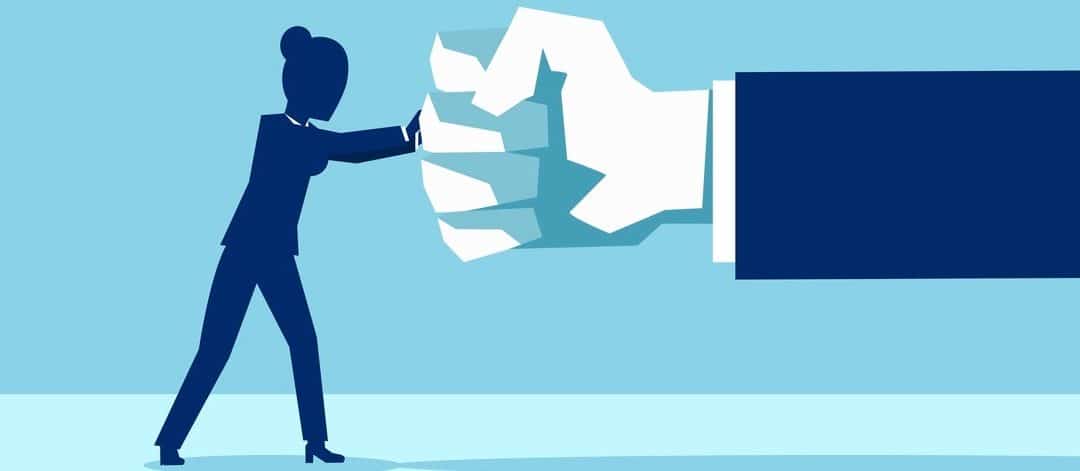 Vector of a woman fighting back a giant fist, protecting herself from work abuse or domestic violence