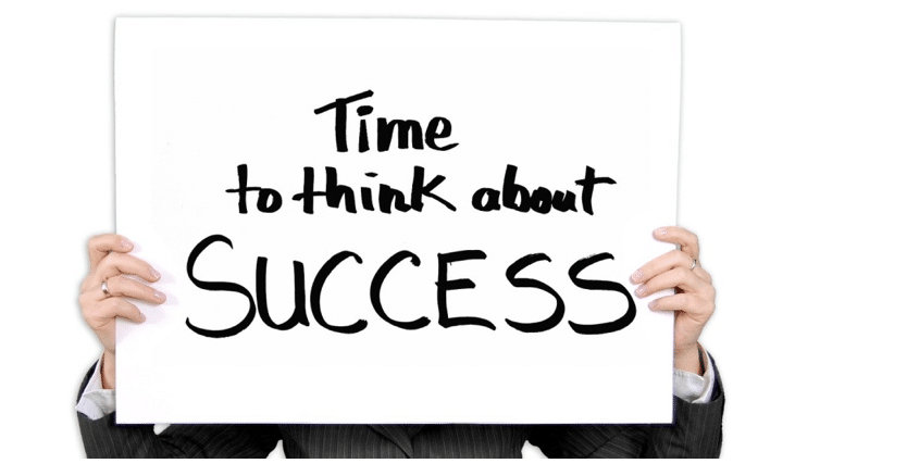 Person holding a “Time to think about success’’ sign.