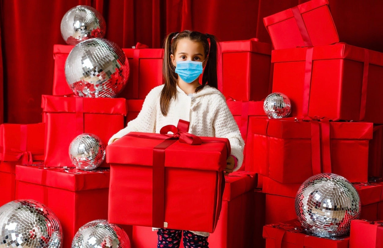 Little girl wearing a mask, Christmas coronavirus and pandemic concept