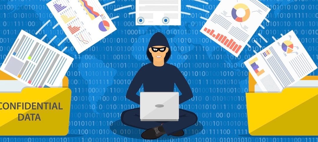 Data phishing, hacker attack.Thief hacker in mask stealing personal information from laptop.