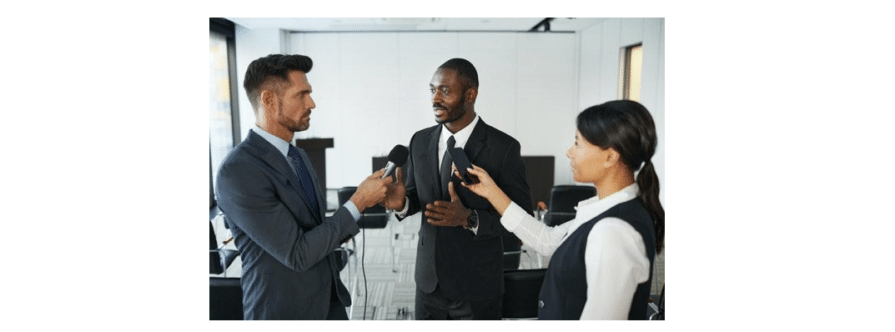 A PR agent speaks with two reporters.