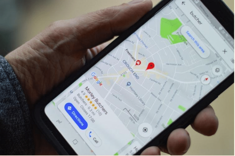 Alt-tag: Person looking up a business on Google Maps.