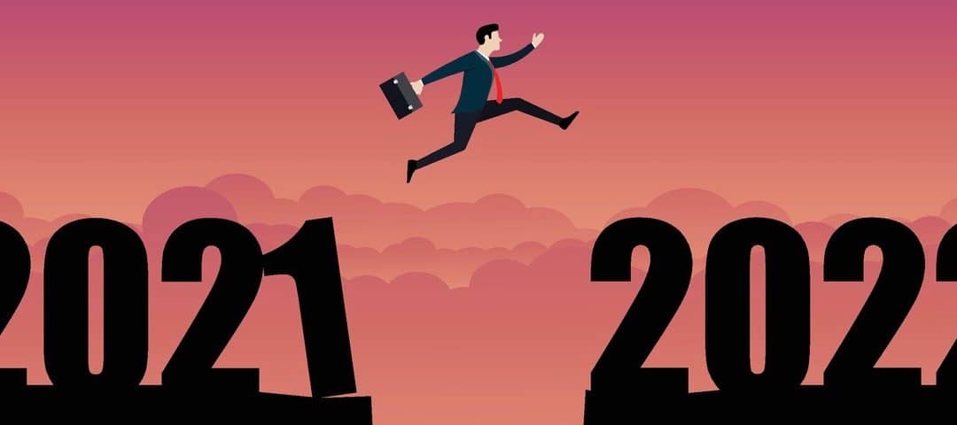 A business person jumping to the new year 2022.