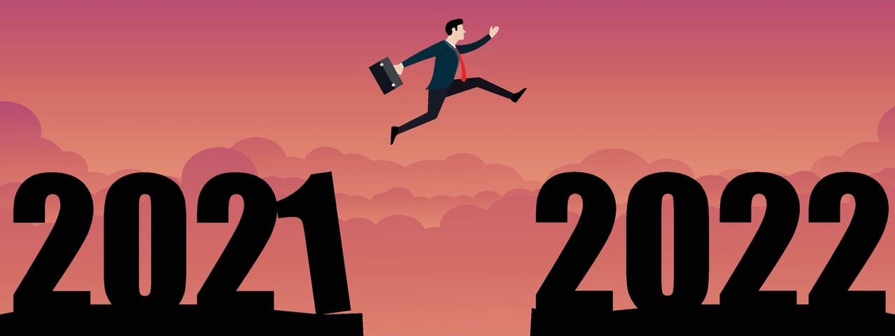 A business person jumping to the new year 2022.
