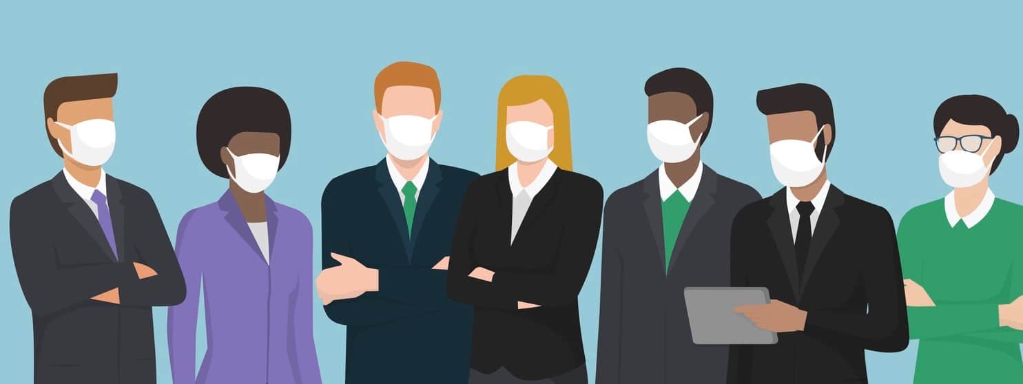 Diverse business people wearing surgical masks and standing together.