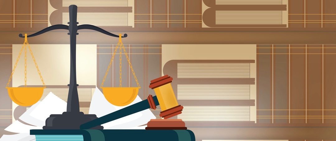 Law books with a judge's gavel on a table and book shelves on background.