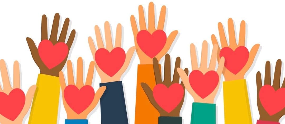 Raised up human hands with red hearts.