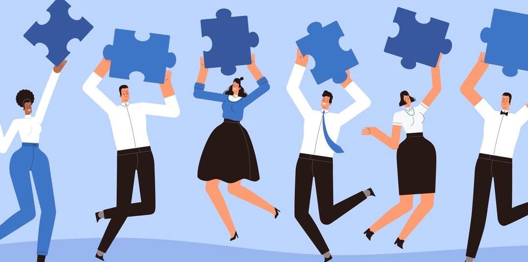 Happy businessmen jump with pieces of puzzles in their hands.