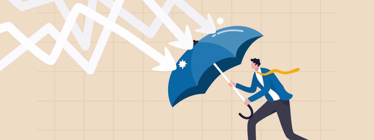 businessman holding umbrella to cover and protect from downturn arrow.