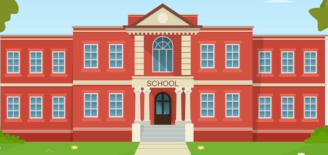 School building facade with green grass and trees.