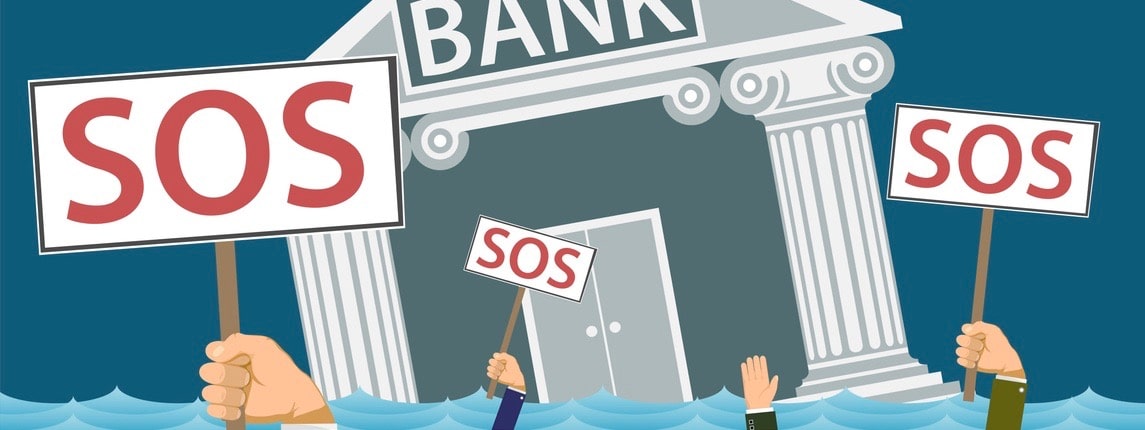 Businessmen hold signs with the word SOS on the background of a sinking bank.