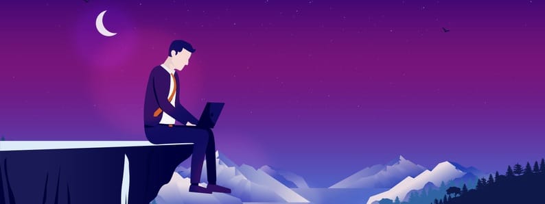Working alone. Man sitting on cliff at night working on laptop computer. Working alone. Man sitting on cliff at night working on laptop computer.