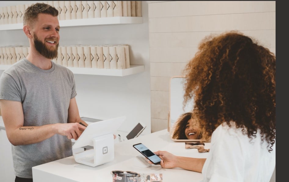 A happy customer talking to an employee. 