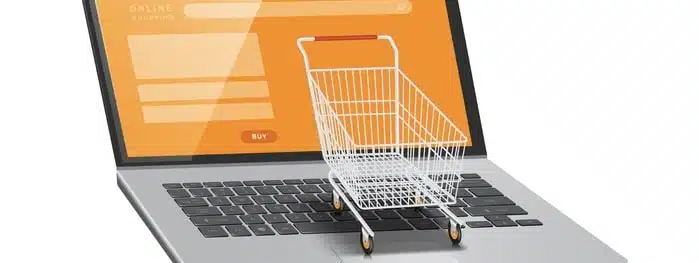 Small Shopping Cart Place On A Laptop Computer With An Orange Screen Small Shopping Cart Place On A Laptop Computer With An Orange Screen