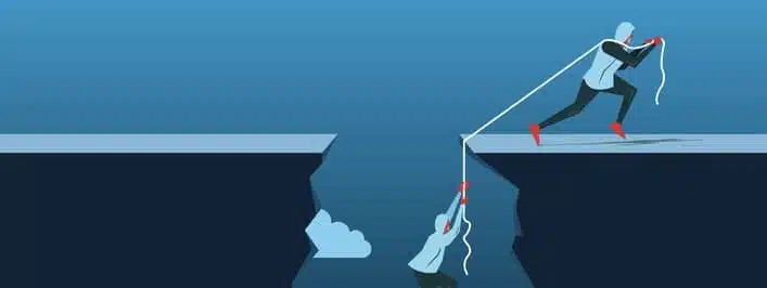 Businessman Pulling Partner Up The Deep